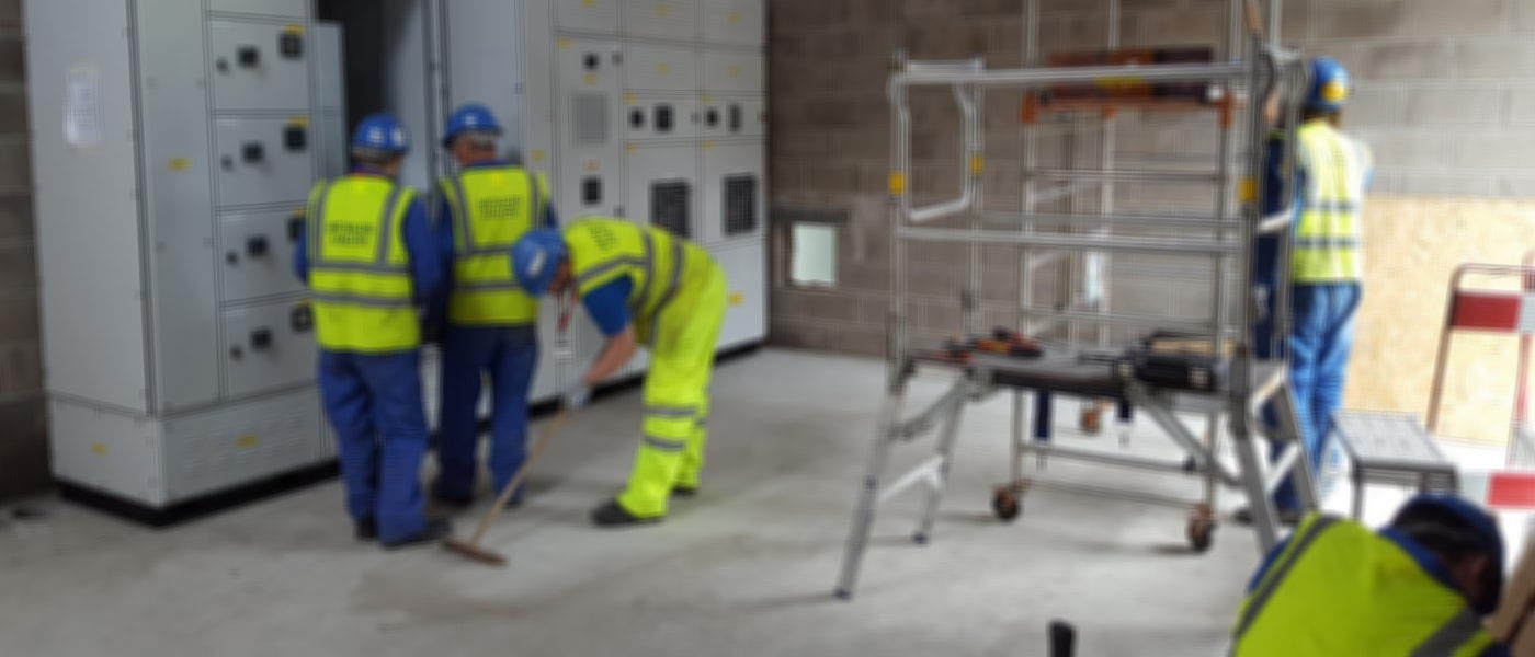 Engineers installing a motor control centre